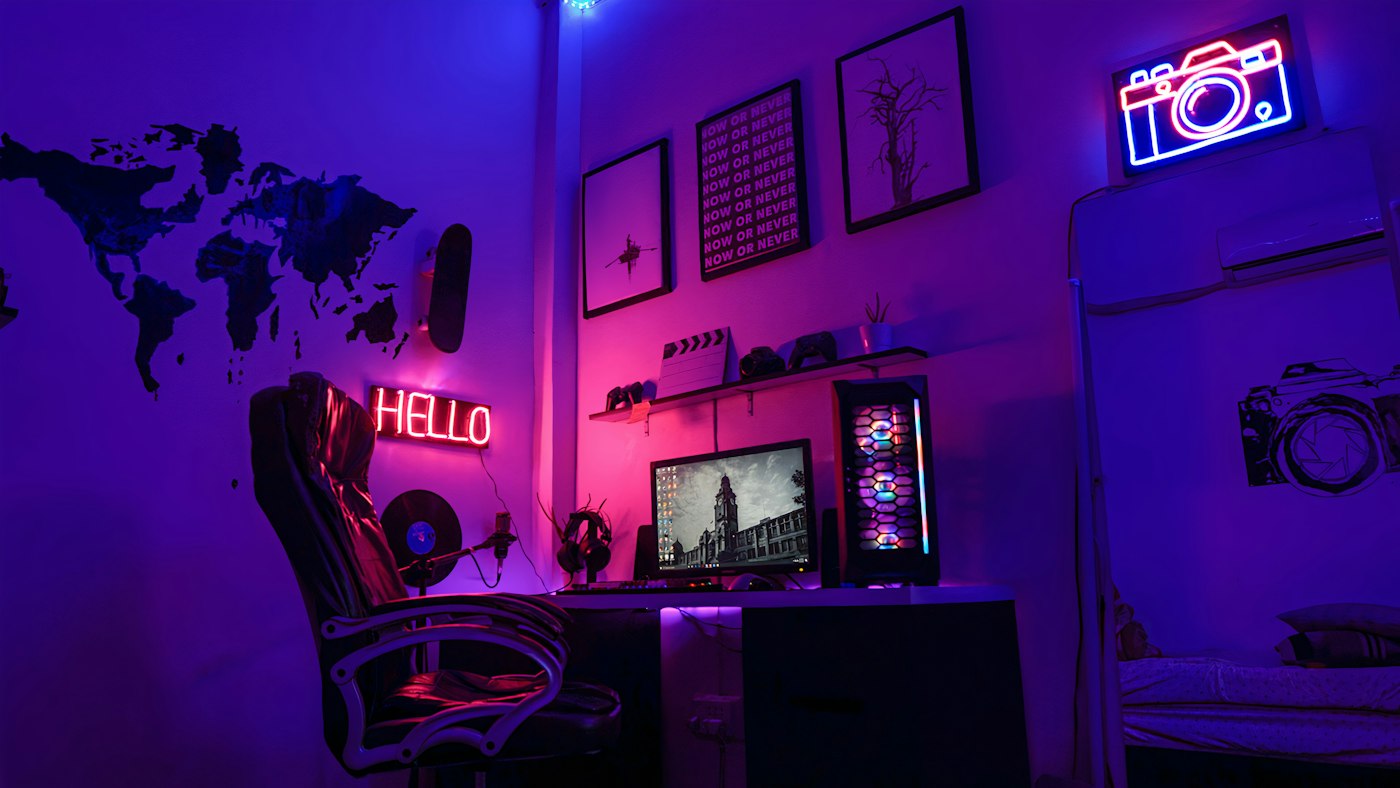 A game studio desk lit by neon